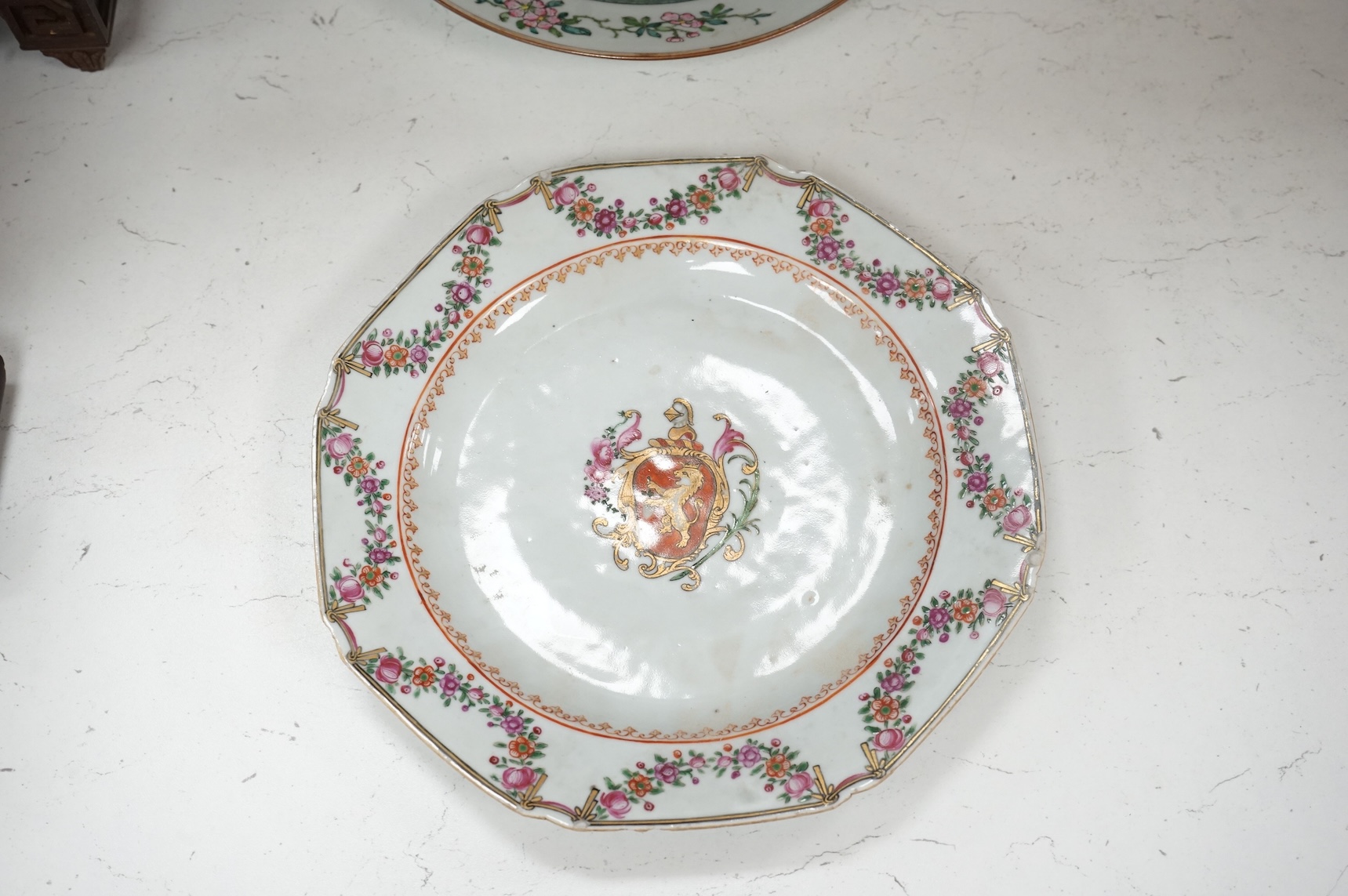 Three Chinese famille rose plates, Qianlong, including an armorial example, largest 22.5cm in diameter